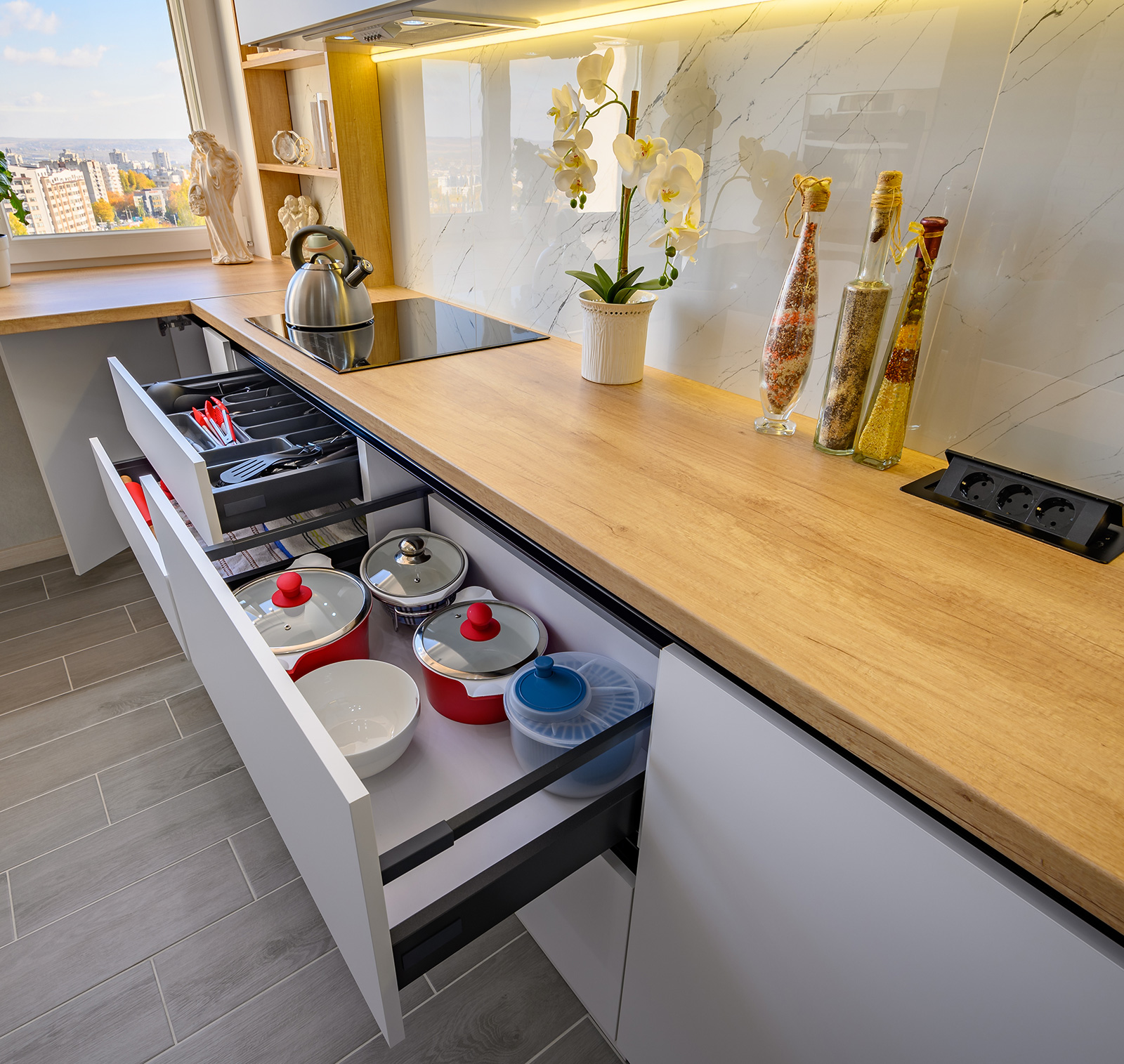 Custom kitchen cabinet interior with pull-out spice rack organizer and integrated drawer dividers