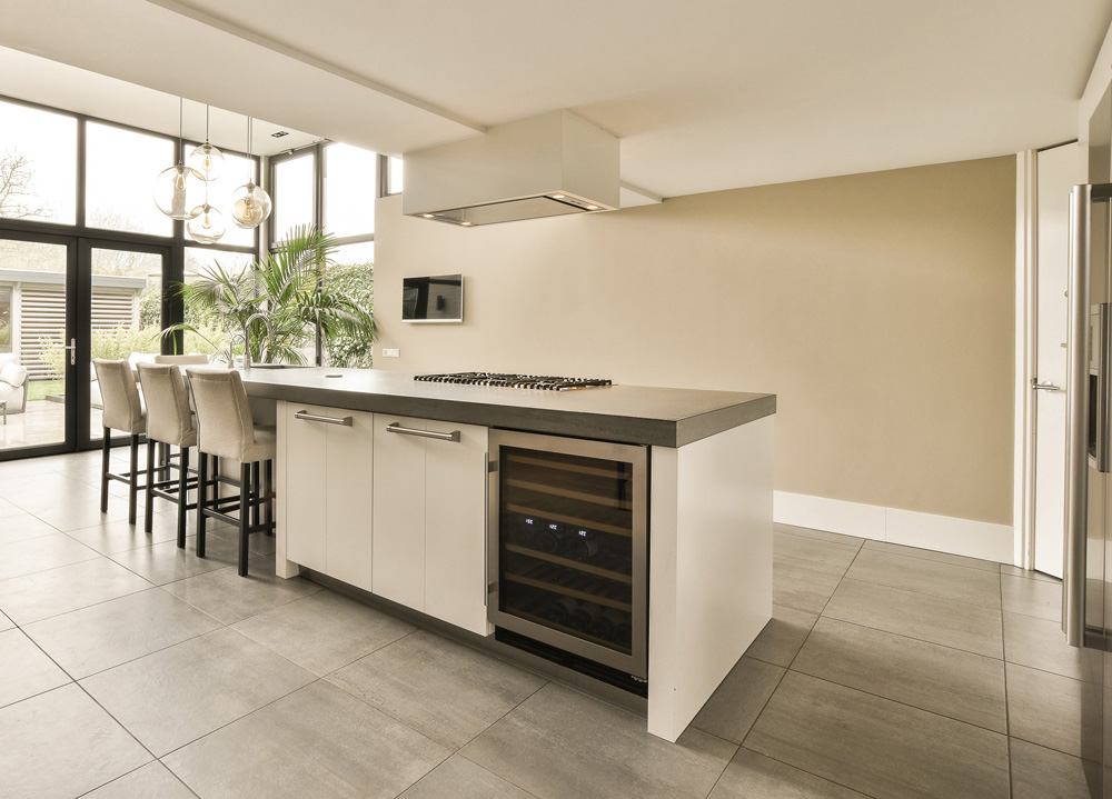 Luxury kitchen island with multiple levels, integrated prep sink, wine storage, and seating for four