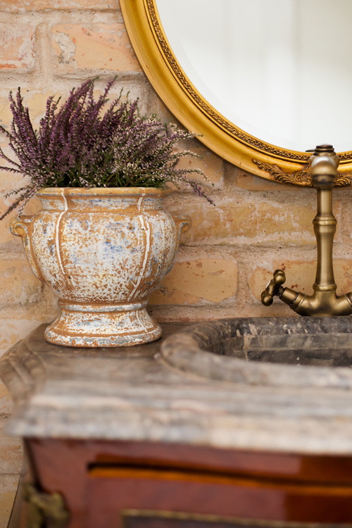 Close-up detail of heritage bathroom renovation showing period-appropriate subway tile, vintage-style brass fixtures, and attention to architectural character preservation in a heritage home