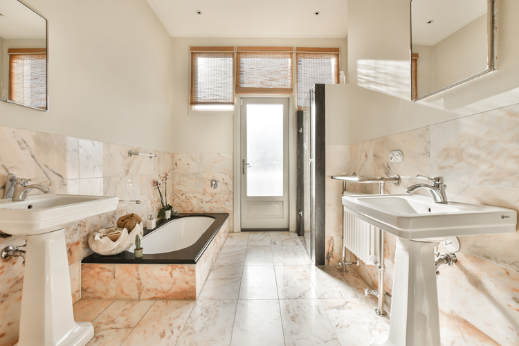 Luxury bathroom showcasing premium natural stone marble countertops, high-end plumbing fixtures, elegant lighting, and carefully selected luxury finishes demonstrating quality craftsmanship