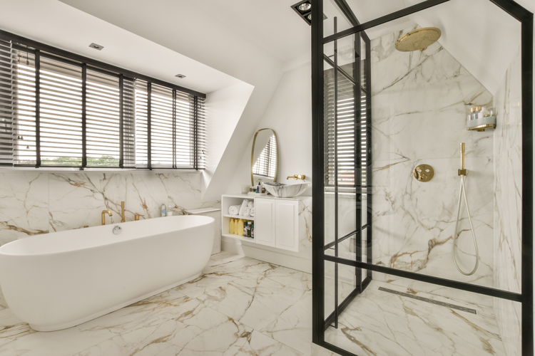 Modern luxury bathroom featuring a freestanding white soaking tub with premium fixtures and spa-inspired design elements