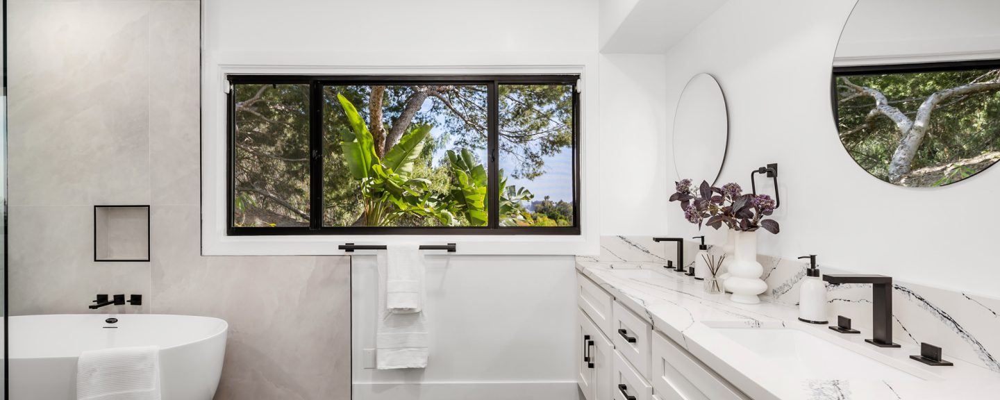 Modern luxury bathroom with custom built-in storage, floating shelves, and integrated cabinetry featuring premium finishes and organized bathroom accessories
